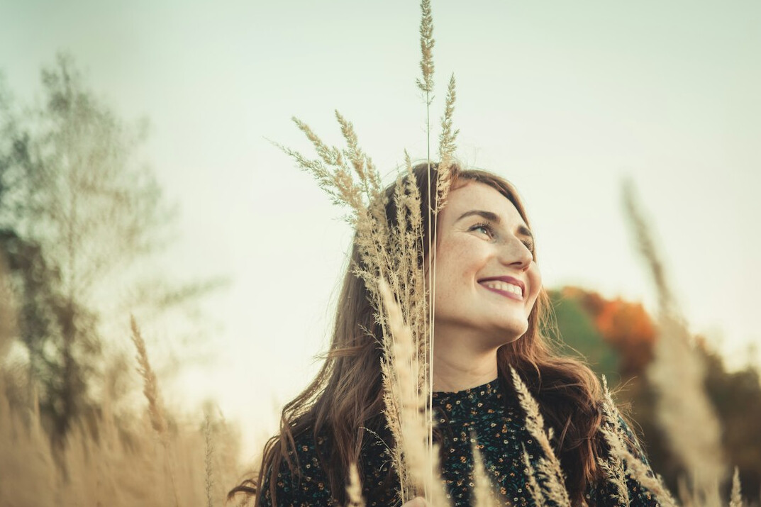 Portrait of a smiling Slovenian woman in her thirties with brown hair in a bright office