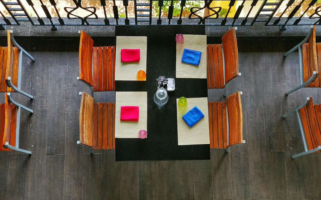 Overhead view of a meeting table with notebooks, pens and printed documents