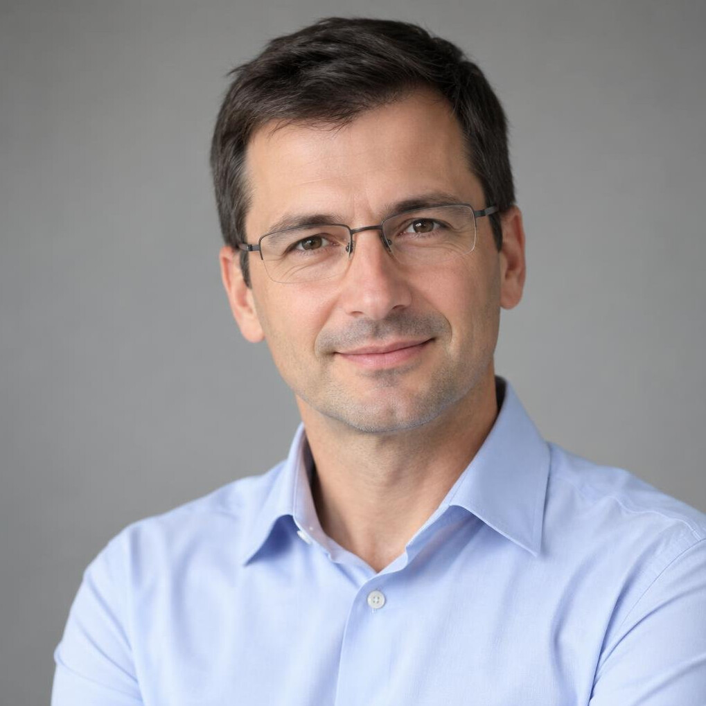 Portrait of a Slovenian man in his forties with short dark hair and glasses